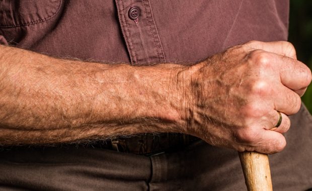 elderly man holding cane